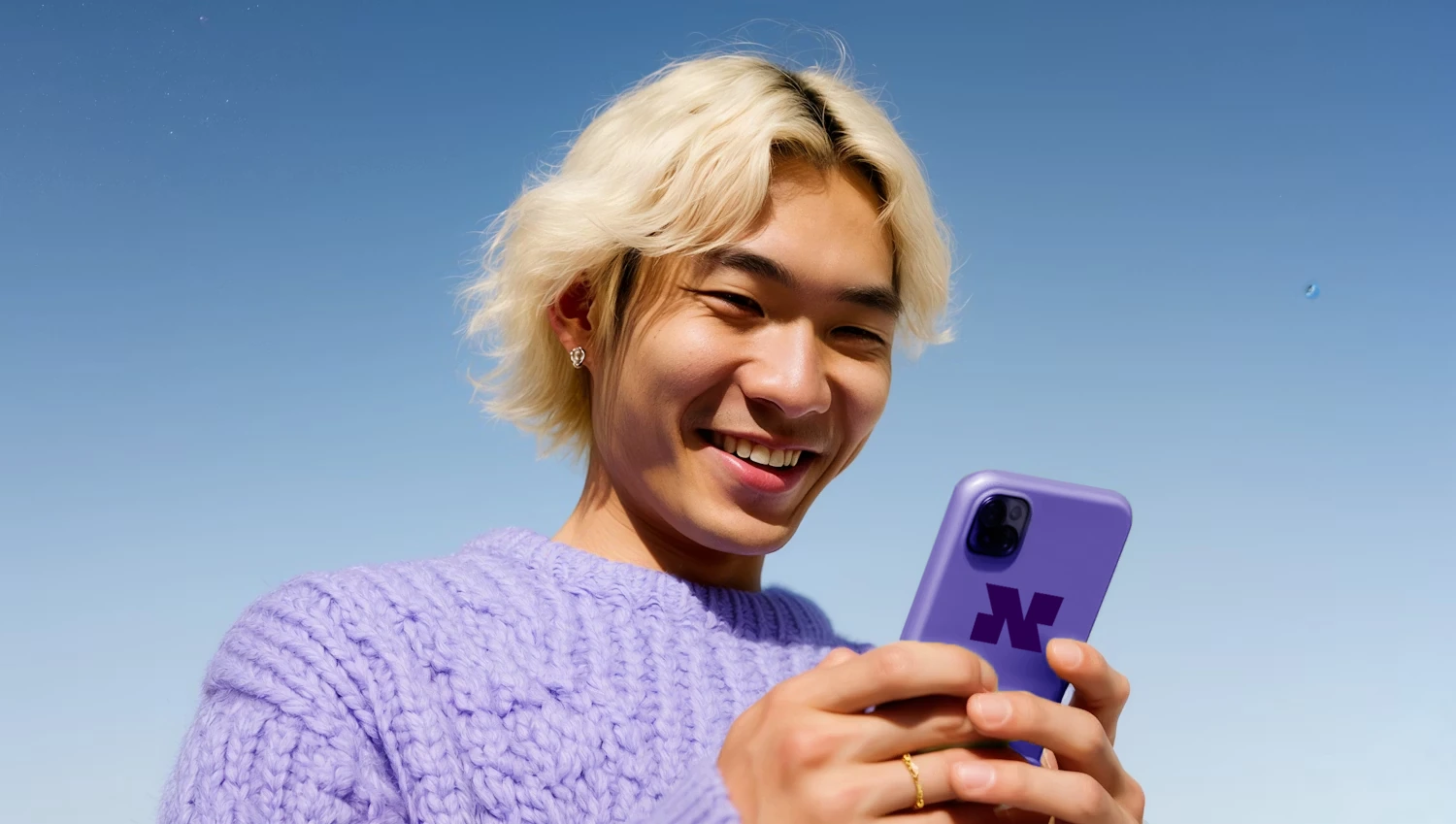 Person smiling while using Niftipay on phone